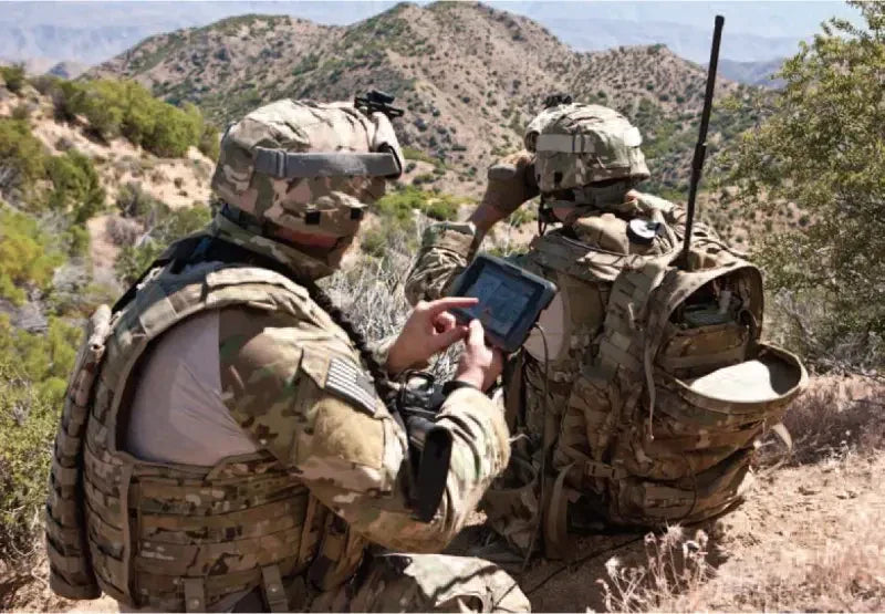 Soldiers using lithium ion batteries-powered cell phones in a desert.