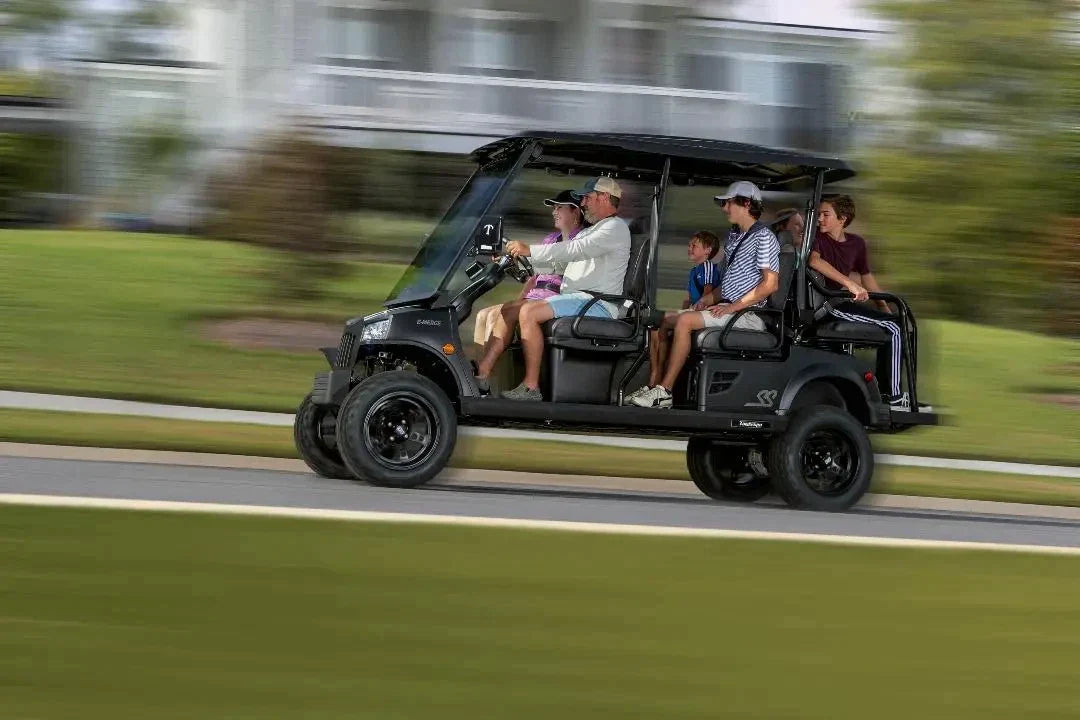 Couple enjoying ride in golf cart powered by premium lithium golf cart batteries