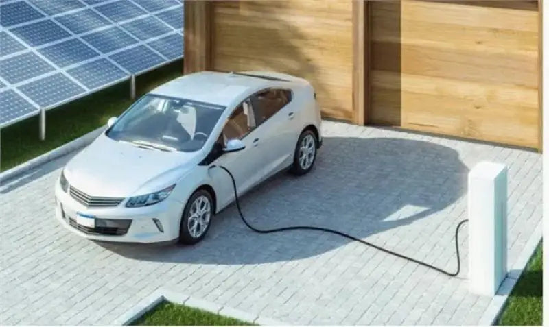 White car charging with a 48V 200AH lithium EV battery pack in front of a house.