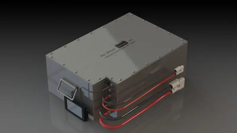24V 100AH lithium ion battery with illuminated red light on metal box.