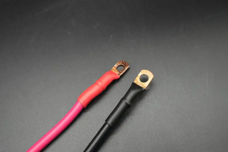 Quick Battery Disconnect cable for 12v, 36v lawn tractor trolling with pink, black, and gold connector.