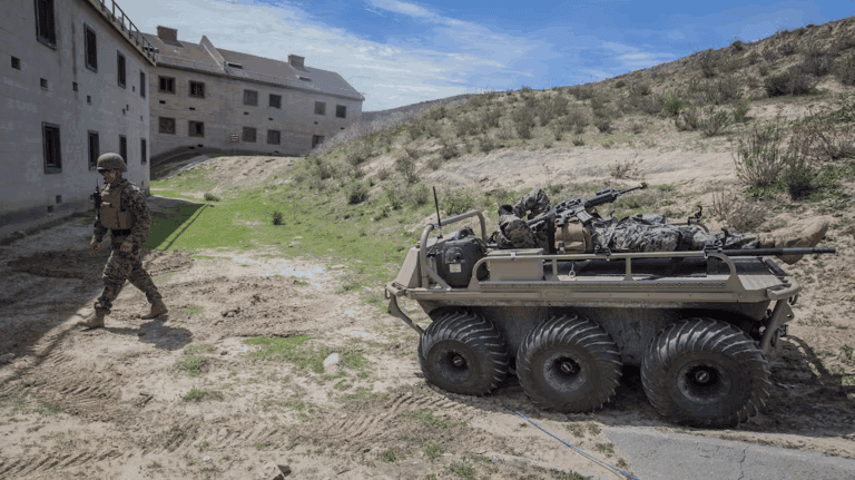 General Dynamics MUTT unmanned ground vehicle powered by Lithium Battery Company 48V 100Ah LiFePO4 batteries in military field operation.